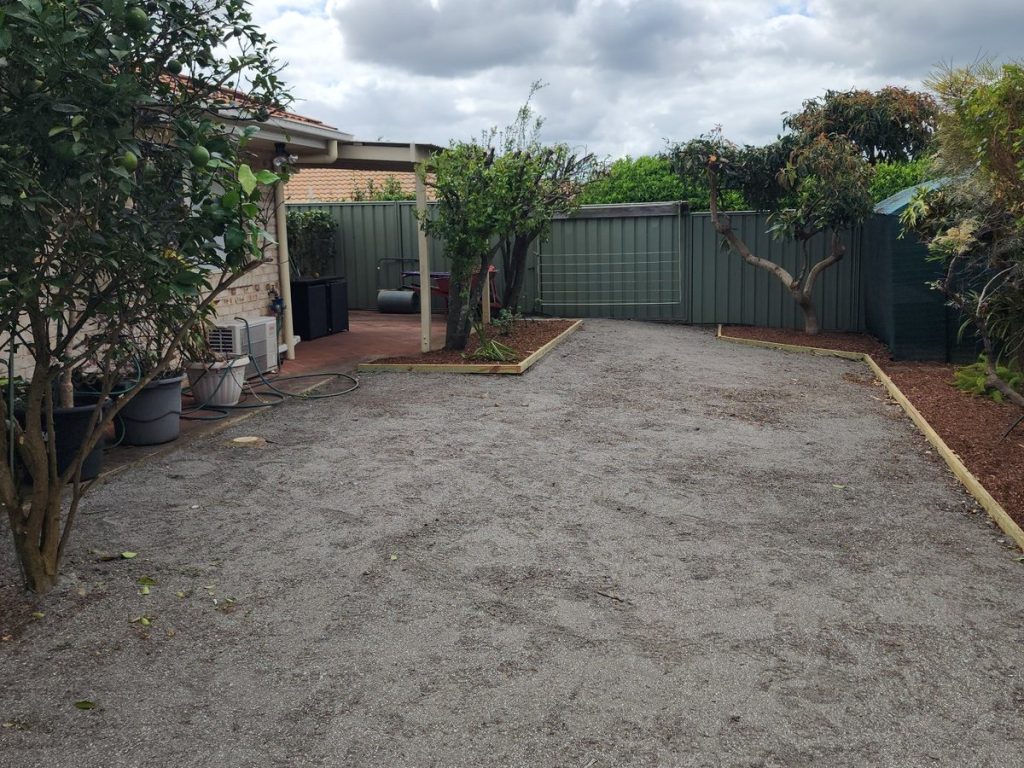 Yard cleared, ground levelled, beds edged and mulched.